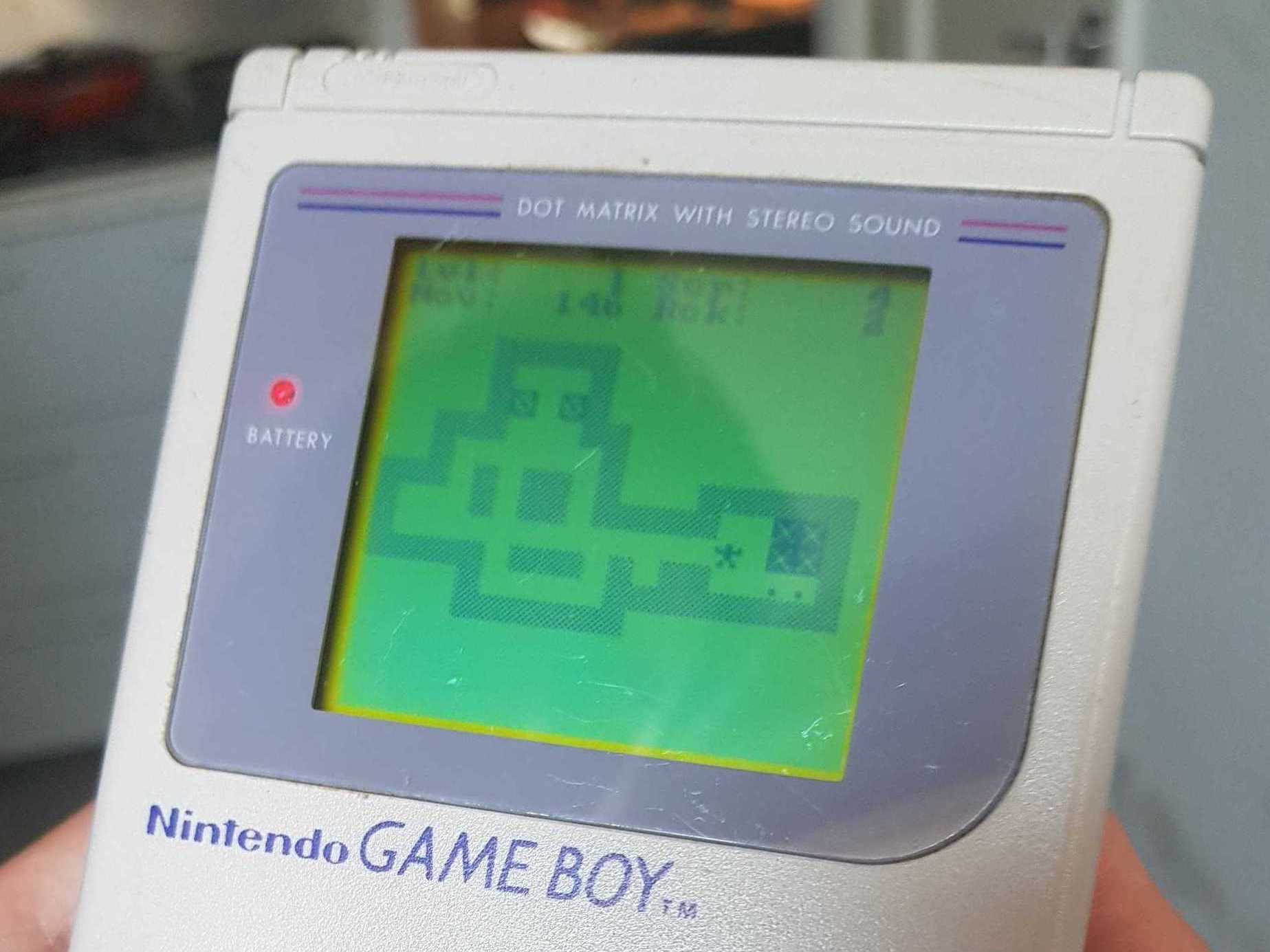 A photo of a grey Game Boy running Sokoban